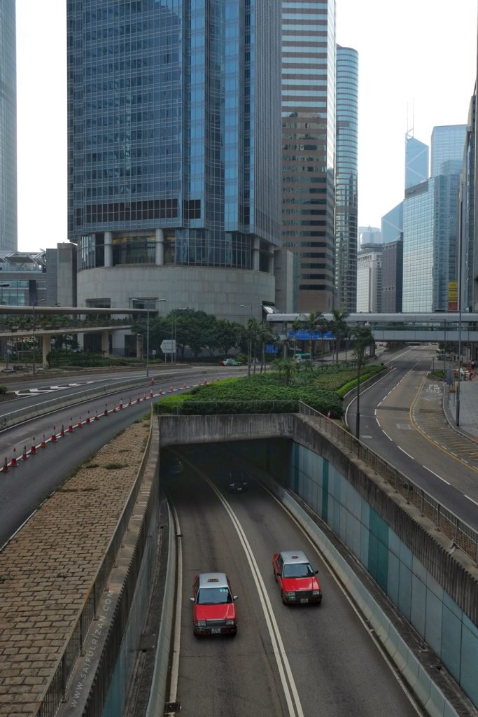 Hong Kong Street with red taxi by Saifulrizan